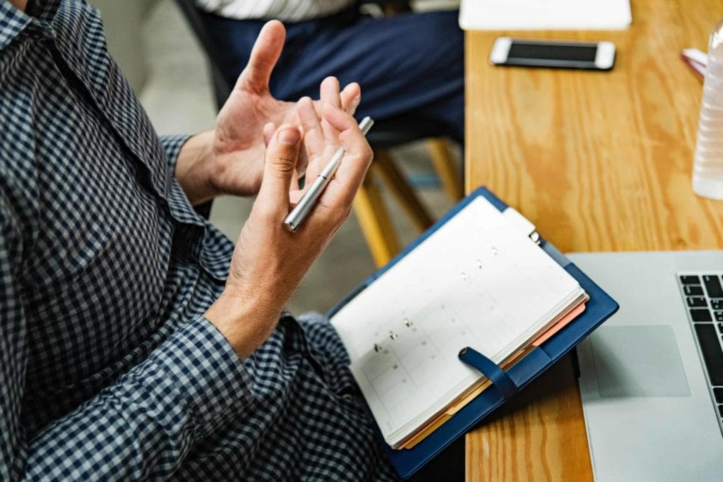 Hands and notepad