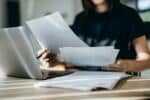 woman handling personal banking and finance with laptop at home