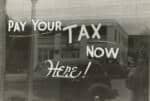 pay your tax now sign on glass door